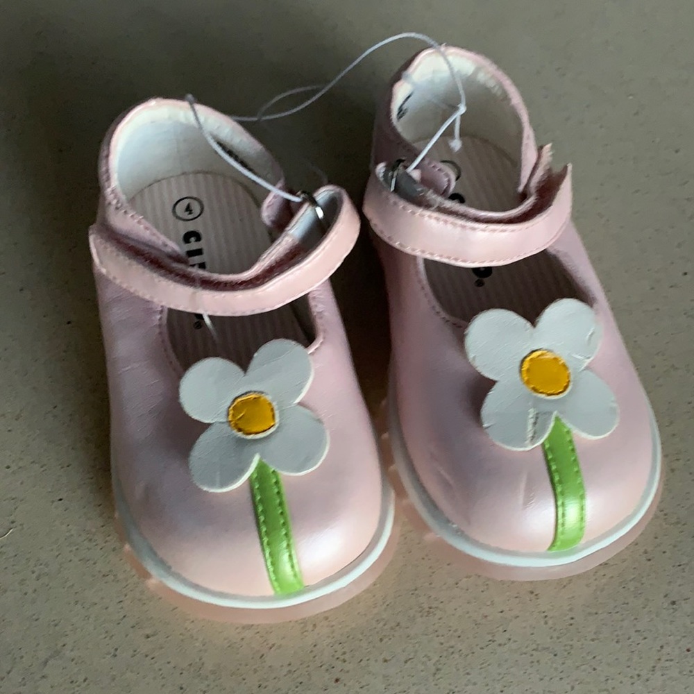 pair of cute baby shoes never worn but has some scratches from storage
